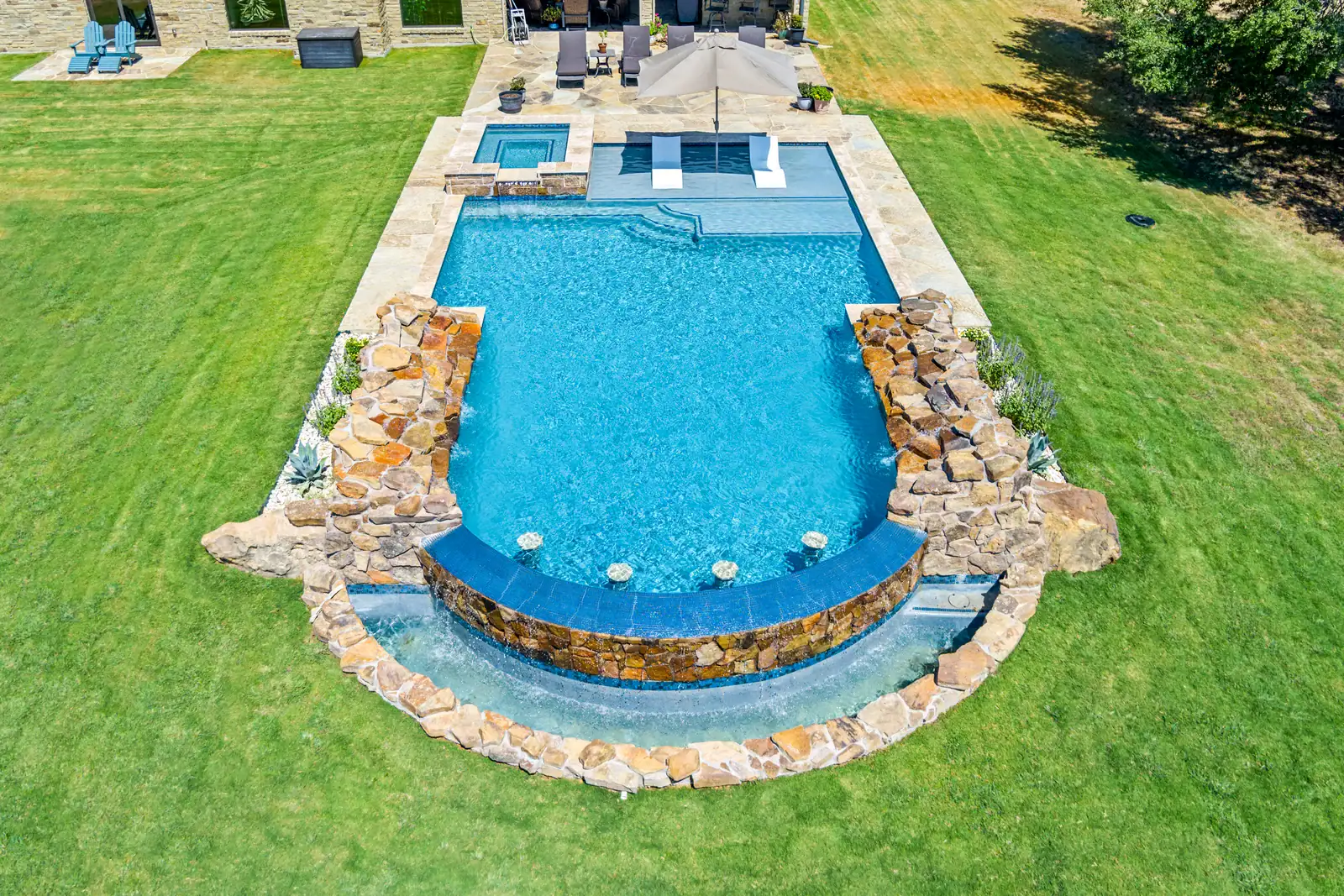 Beautiful modern house with pool and hot tub at sunset, outdoor lighting, and spacious backyard.